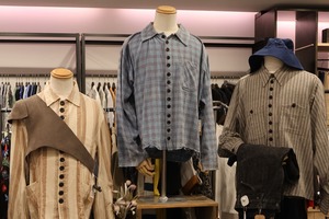 Store display with mannequins wearing checked and striped shirts