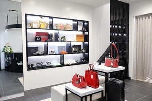 Bright store display featuring luxury designer bags and shoes