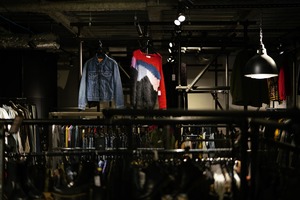 Denim jackets and knitwear displayed in a softly lit store interior