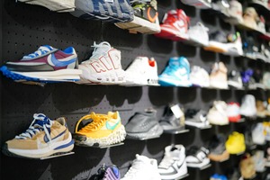 Streetwear shoe section with sneakers displayed along the wall