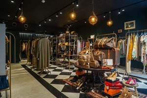Vintage-inspired store interior displaying bags and clothing
