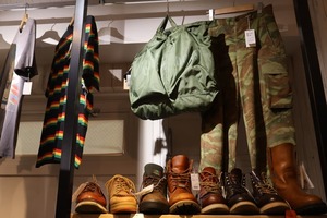 Store display featuring vintage workwear, boots, bags, and clothing